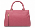 Pink handbag with gold accents on a white background