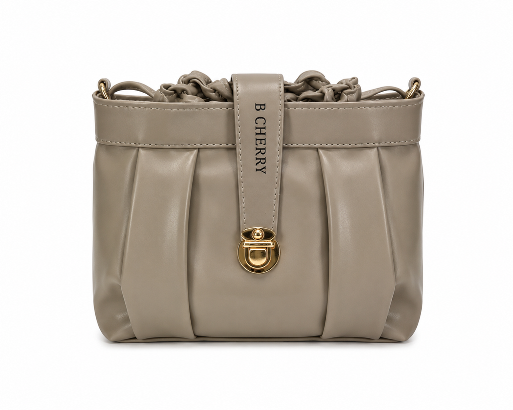 Beige handbag with gold lock and 'B Cherry' strap on a white background