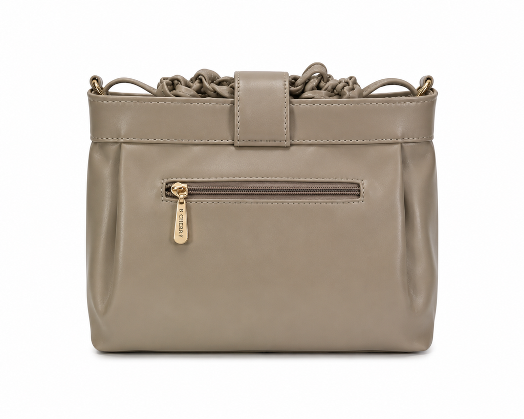 Beige handbag with gold zipper on a white background