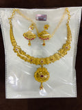 Gold necklace and earrings set on a white card with gold weight label.