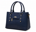 Navy blue handbag with gold accents on a white background