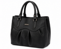 Black handbag with a visible brand label on a white background