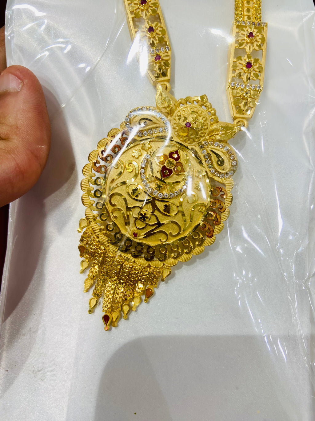 Gold necklace with intricate design on a white background