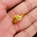 Gold ring with a peacock design on a person's hand