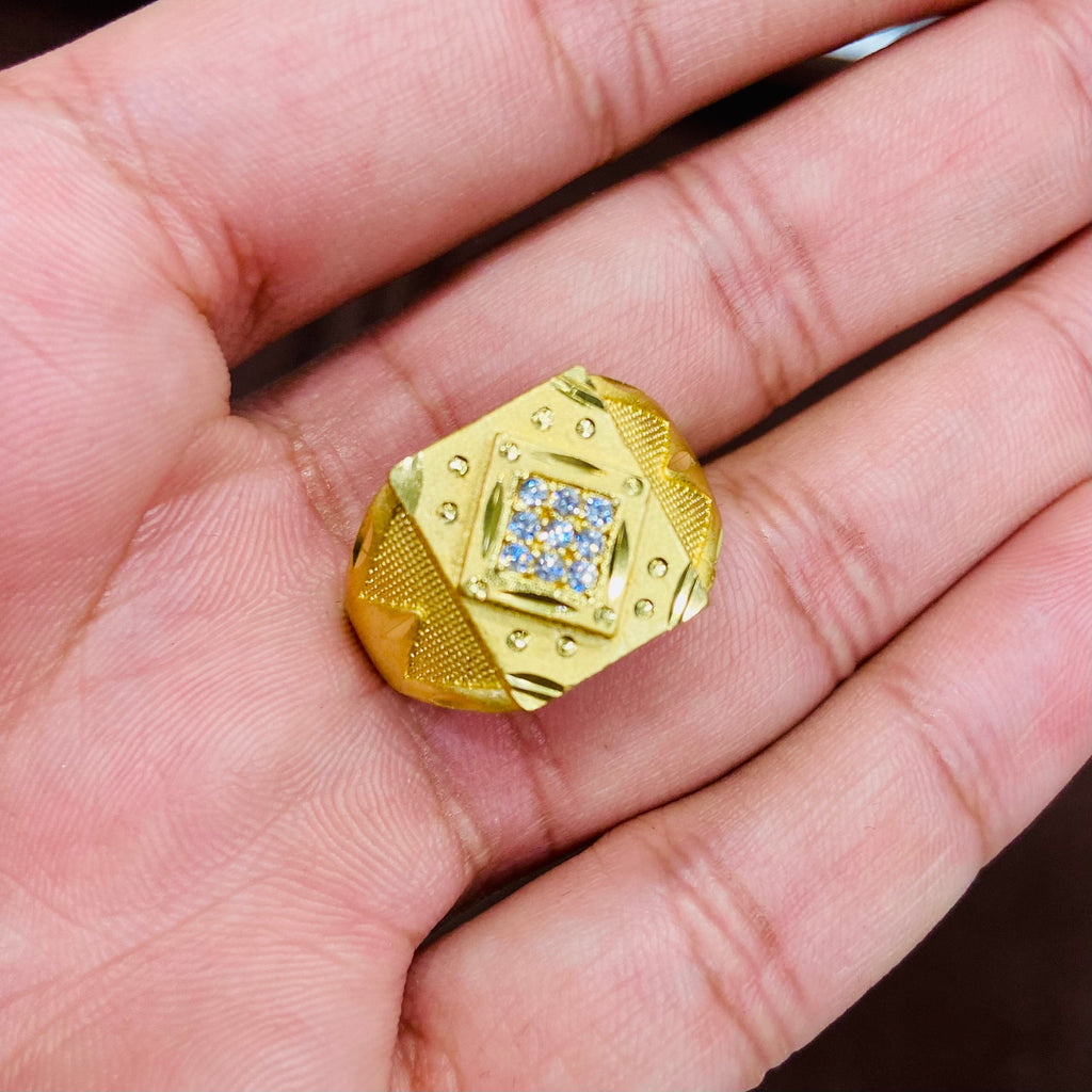 Gold ring with gemstones on a hand