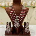 Jewelry set with necklace and earrings on a brown mannequin bust.