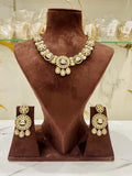 Jewelry set with necklace and earrings on a brown velvet stand.
