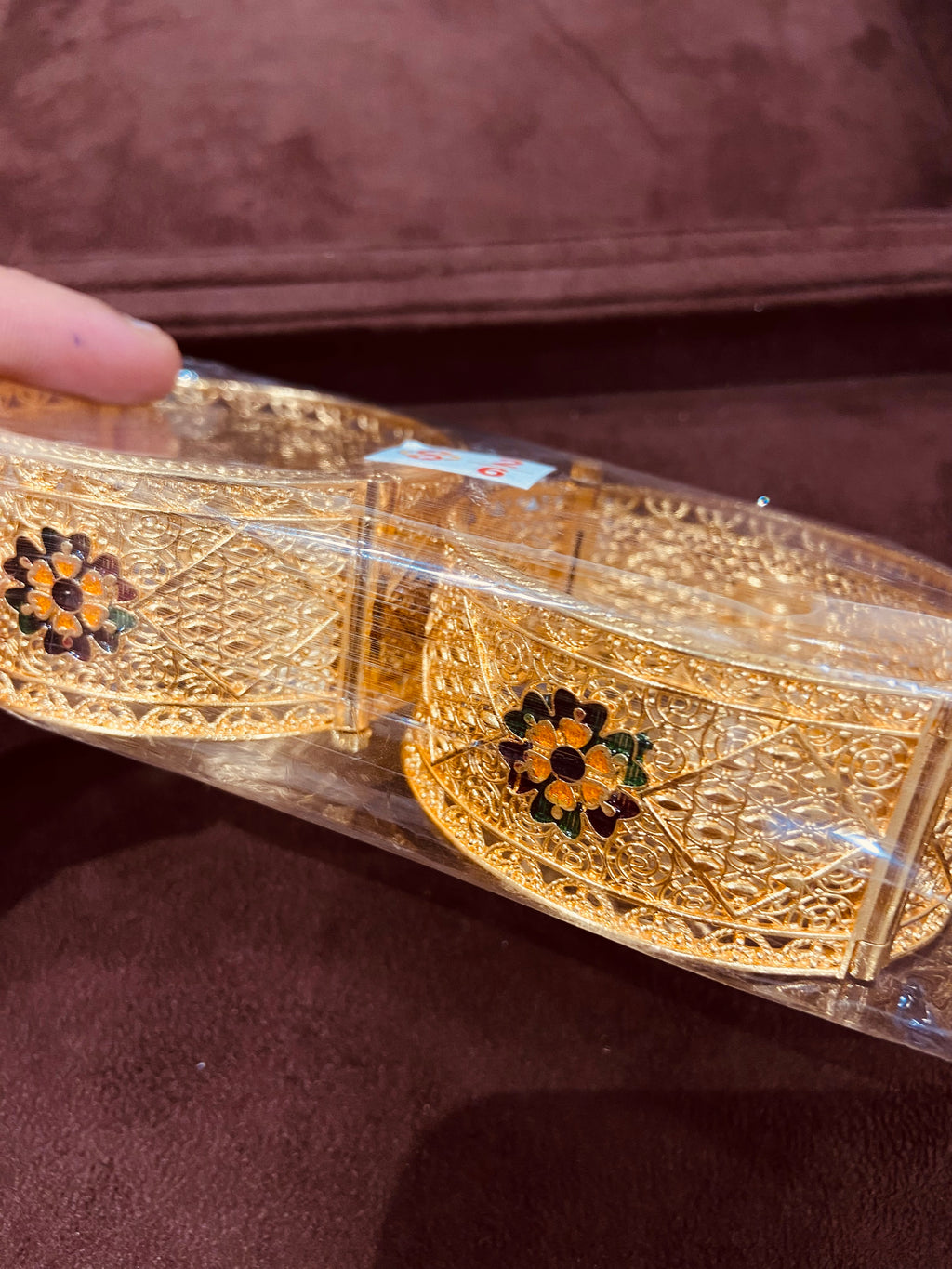Gold belt with decorative elements on a brown background