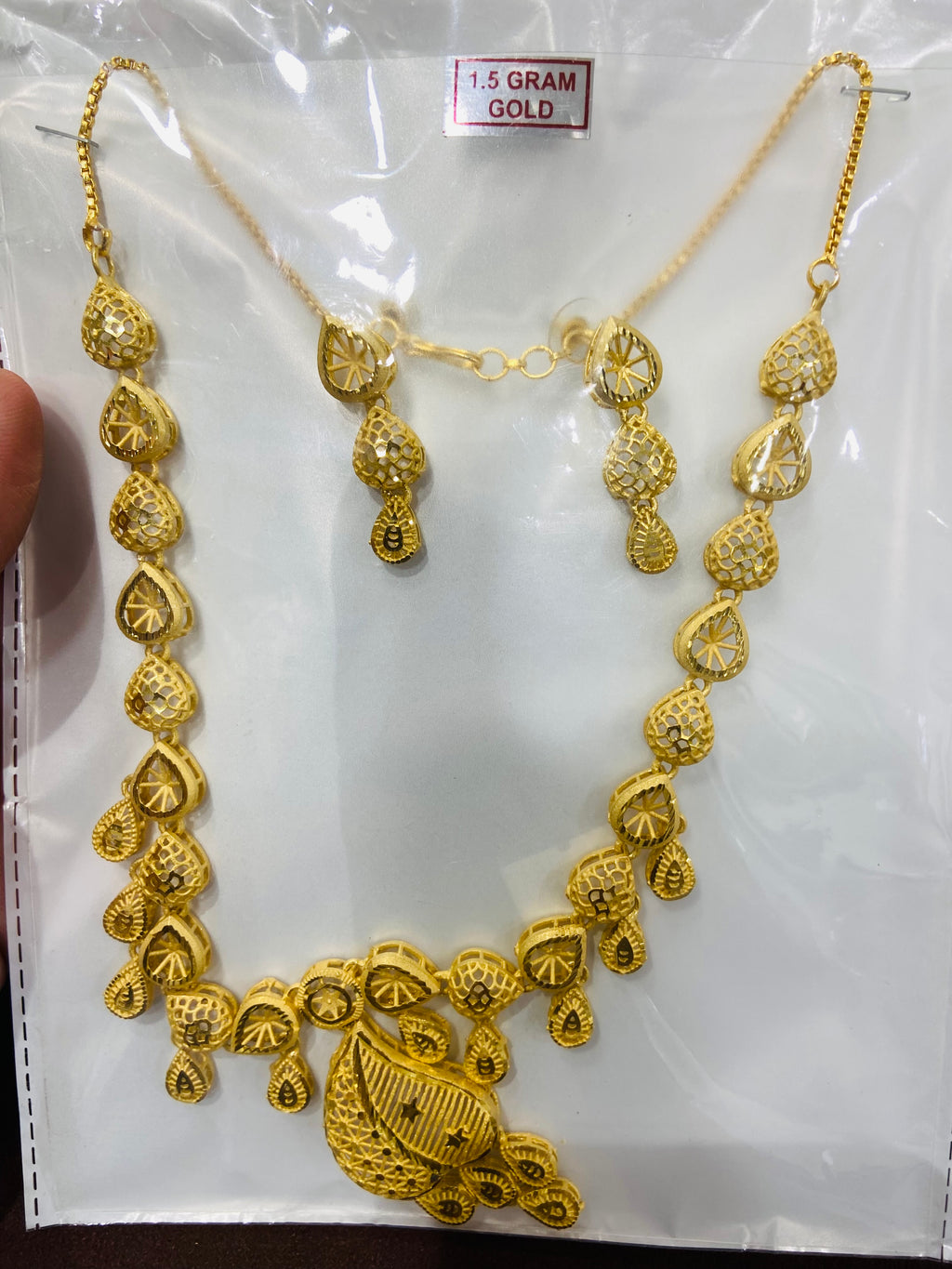 Gold necklace on a white background with '1.5 Gram Gold' label.