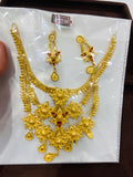 Gold necklace and earrings set on a white card with gold weight label.