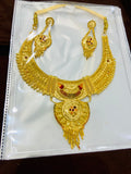 Gold necklace and earrings set on a white background