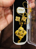 Gold jewelry set with necklace and earrings on a Jewellers branded card.