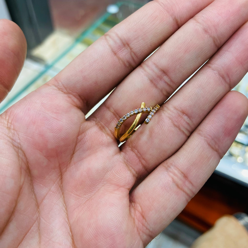 Gold ring with a diamond on a person's hand