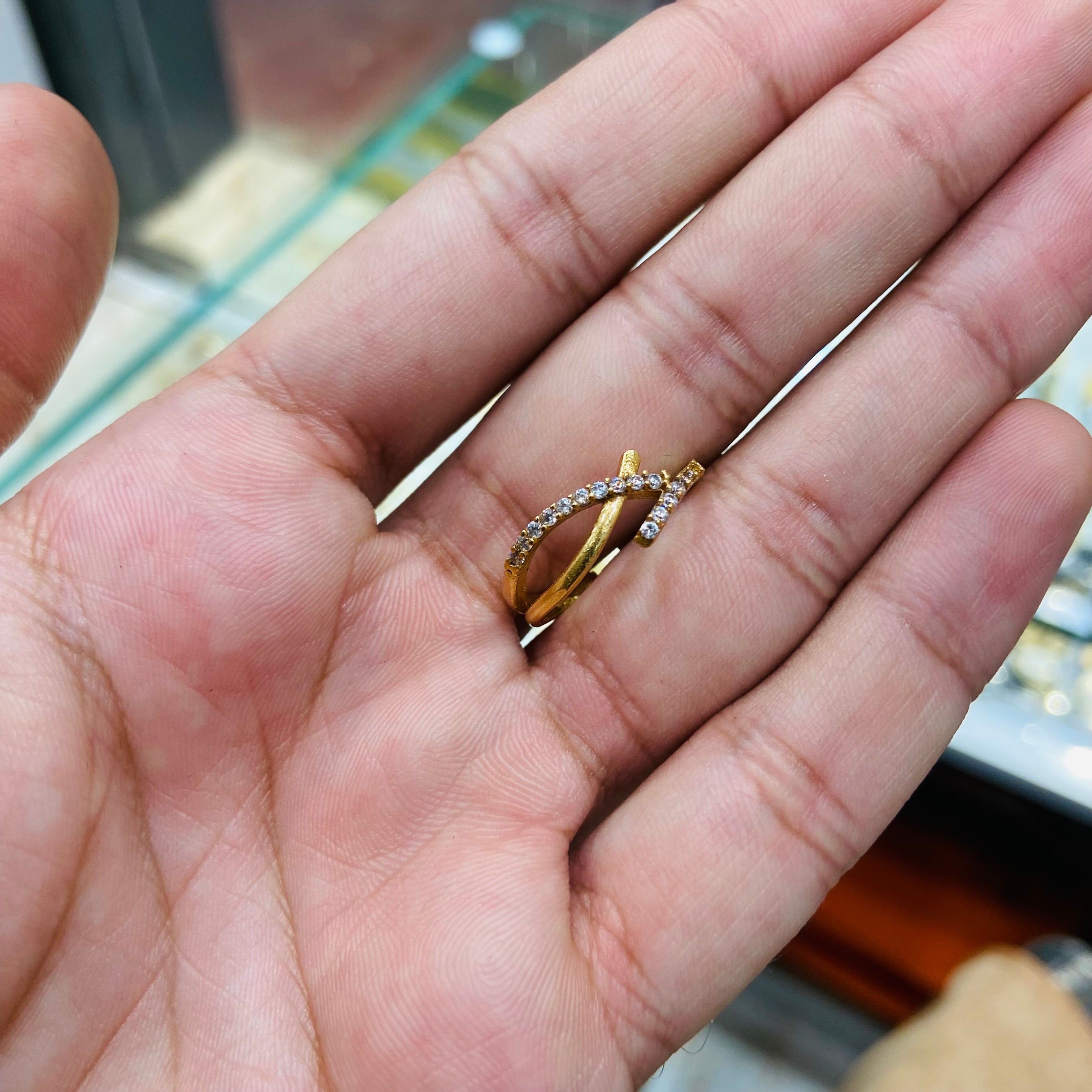 Gold ring with a diamond on a person's hand