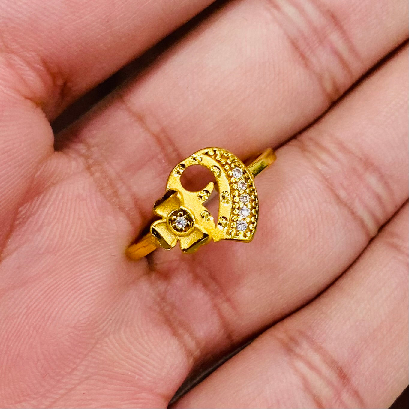 Gold ring with a unique design on a hand