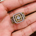 Gold and diamond ring held in a hand