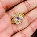 Gold ring with gemstones held in a hand