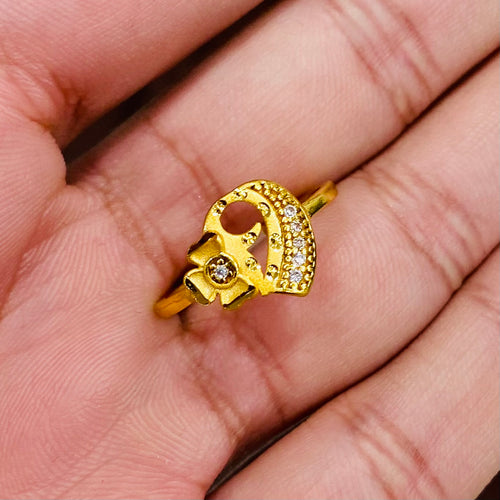 Gold ring with a unique design on a hand