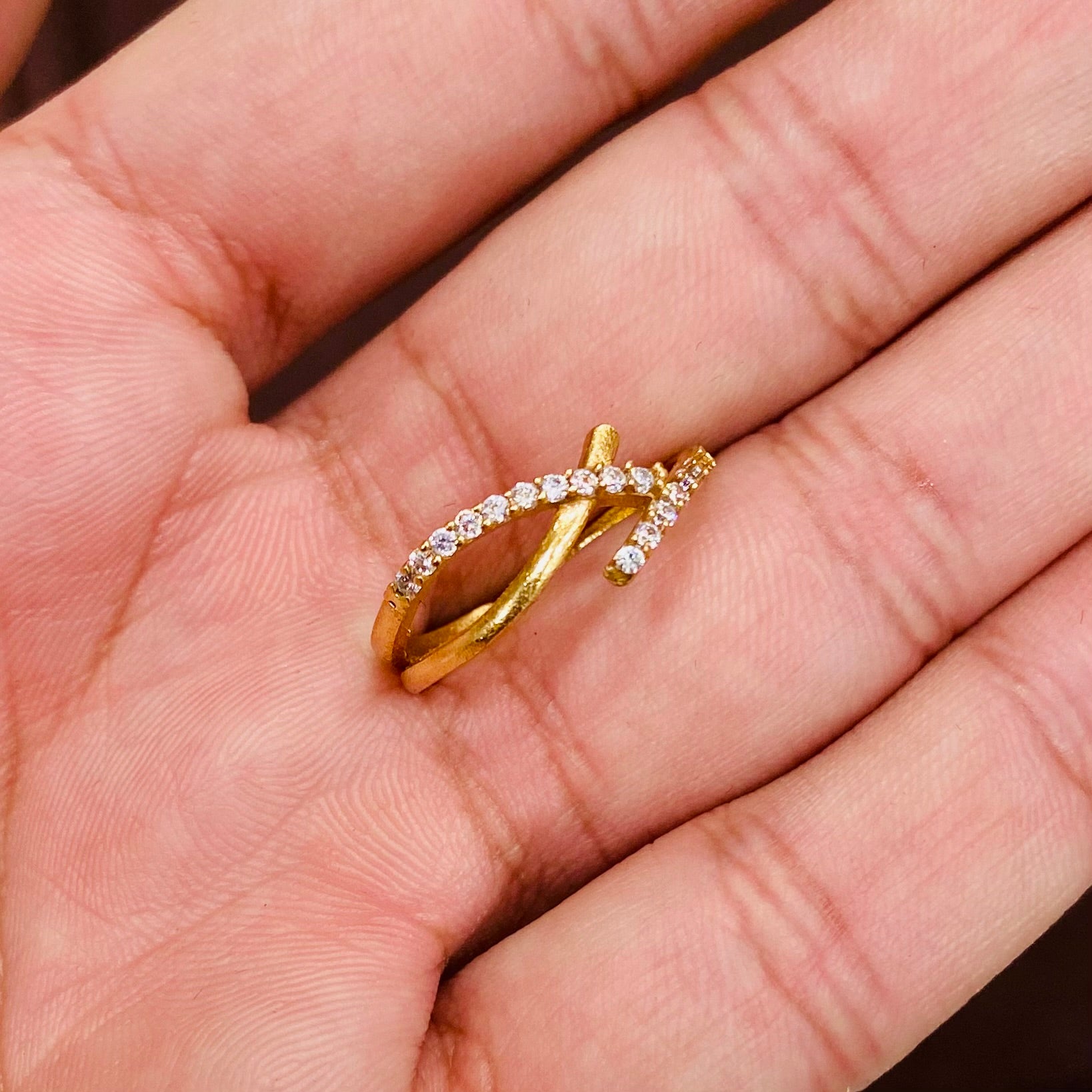 Gold ring with diamonds on a hand