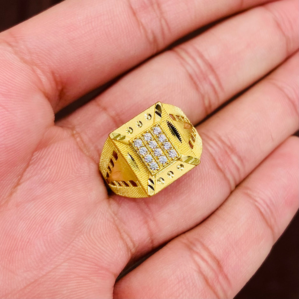 Gold ring with embedded diamonds on a hand