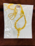 Gold necklace on a white card with gold weight tag