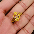 Gold ring with floral design on a hand