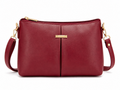 Red handbag with gold accents on a white background