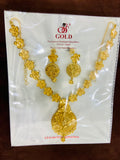 Gold necklace and earrings set on a Gold brand packaging