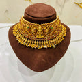 Gold necklace on a brown mannequin head with a marble background